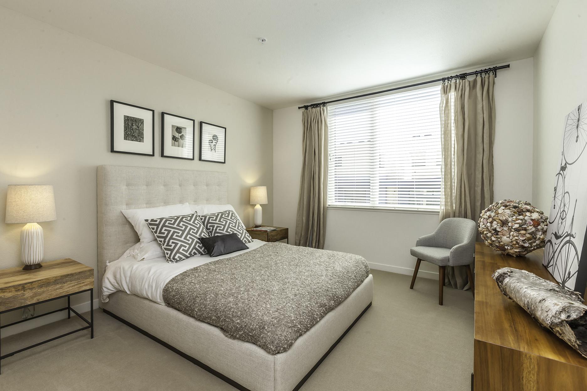 Newly Renovated Apartments in Foster City CA-One Hundred Grand Master Bedroom with Wall to Wall Carpeting and a Large Window Letting in Natural Lighting